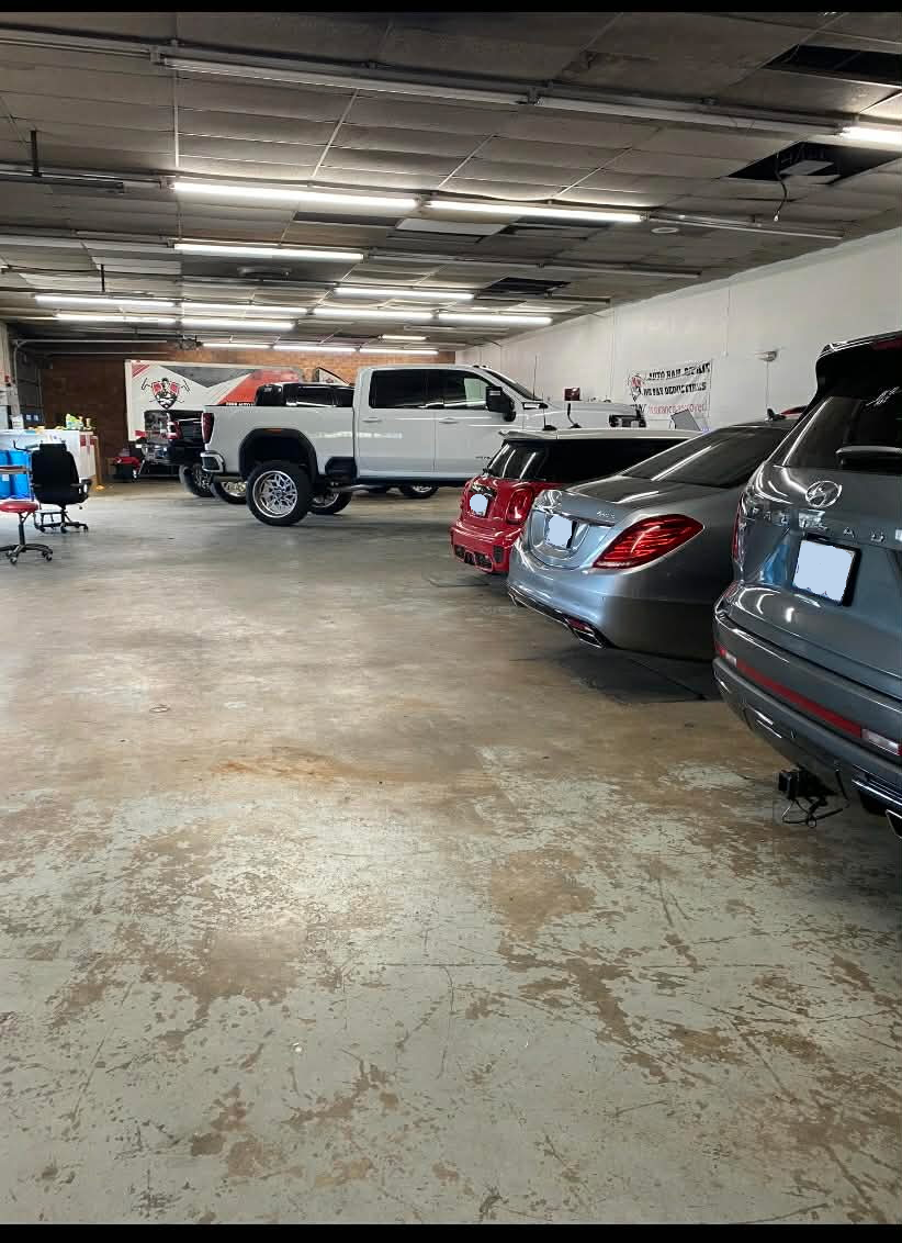 Busy dent repair shop view related to New Smyrna Beach paintless dent repair