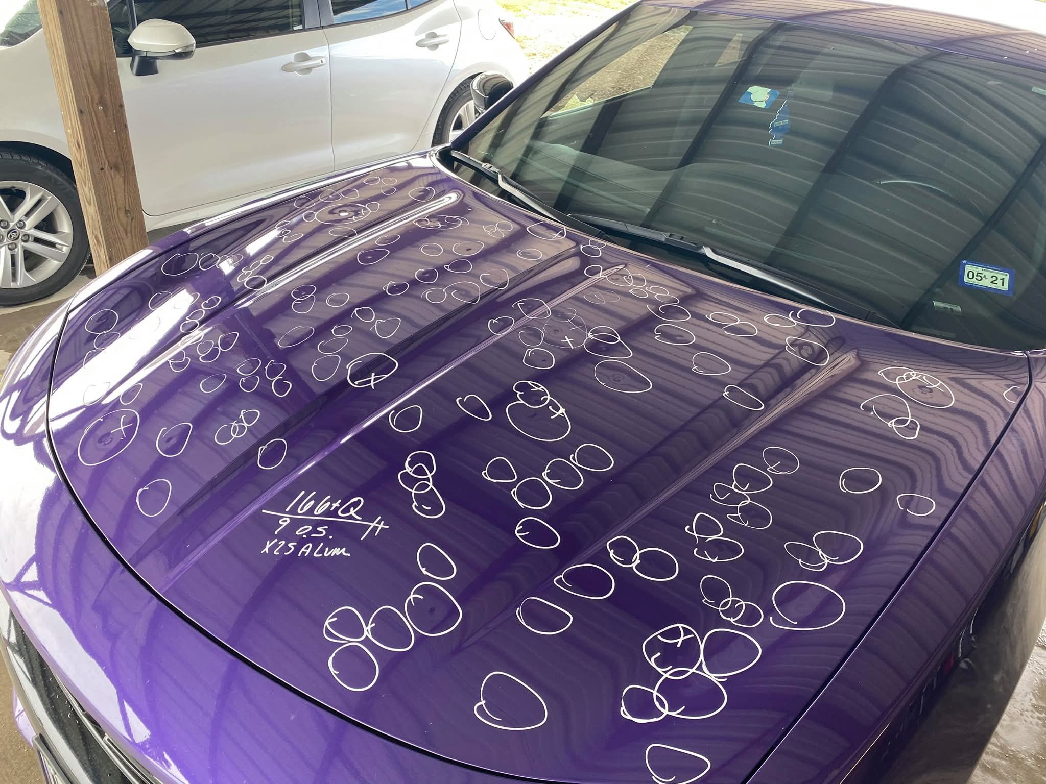 Vehicle with hail damage marked for dent repair